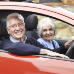 Portrait Of Smiling Senior Couple Out For Drive In Car