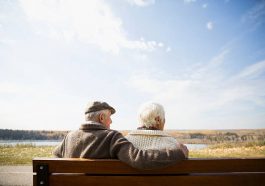 Couple de personnes âgées assis sur un banc et regardant au loin le paysage