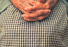 Femme âgée les mains croisées sur les genoux